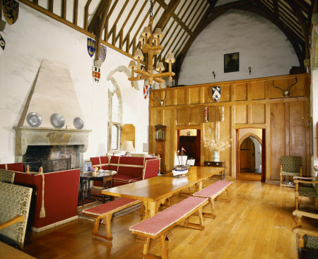 Compton Castle, The Hall showing the fireplace, long table and benches, roof timbers, screens and panelling of oak - National Trust Images