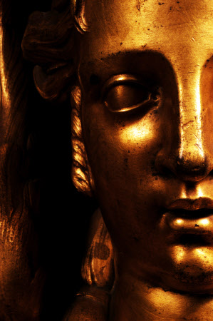Close view of an ormolu winged sphinx on a black Boulle-work commode in the Carved Room at Petworth House, West Sussex